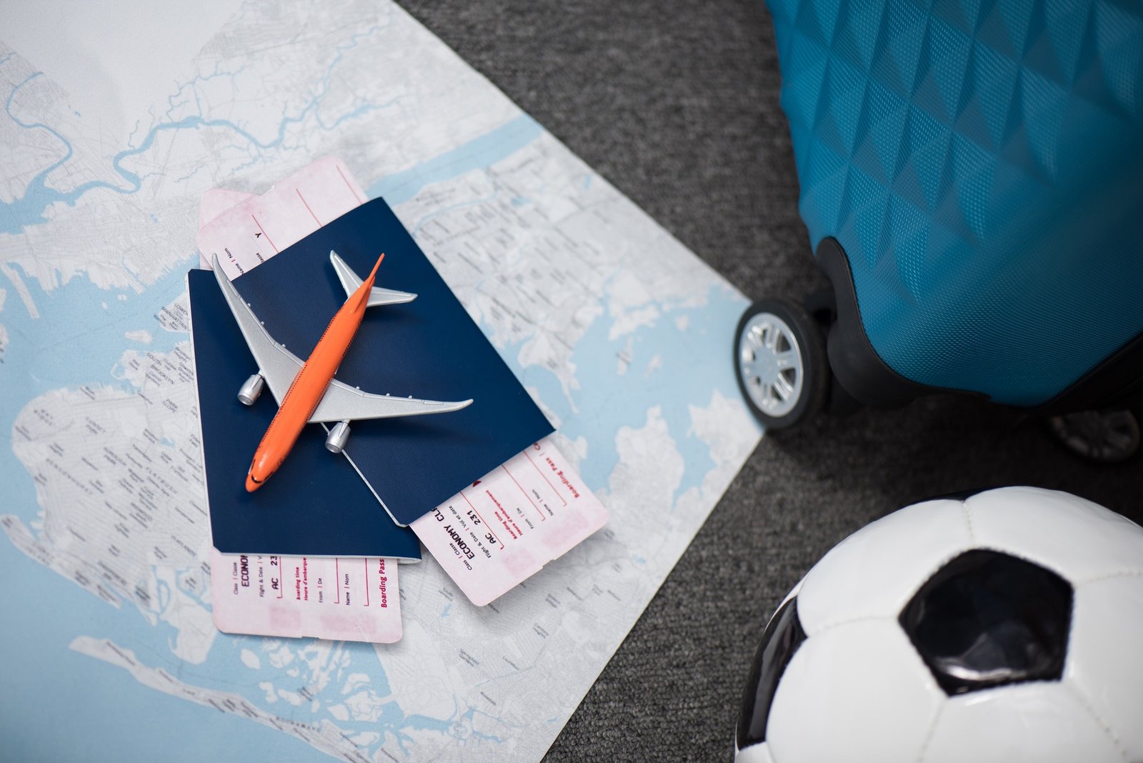 composition of flight tickets with toy airplane laying on map
